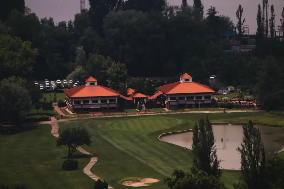 Clubhouse beside a pond and lawns