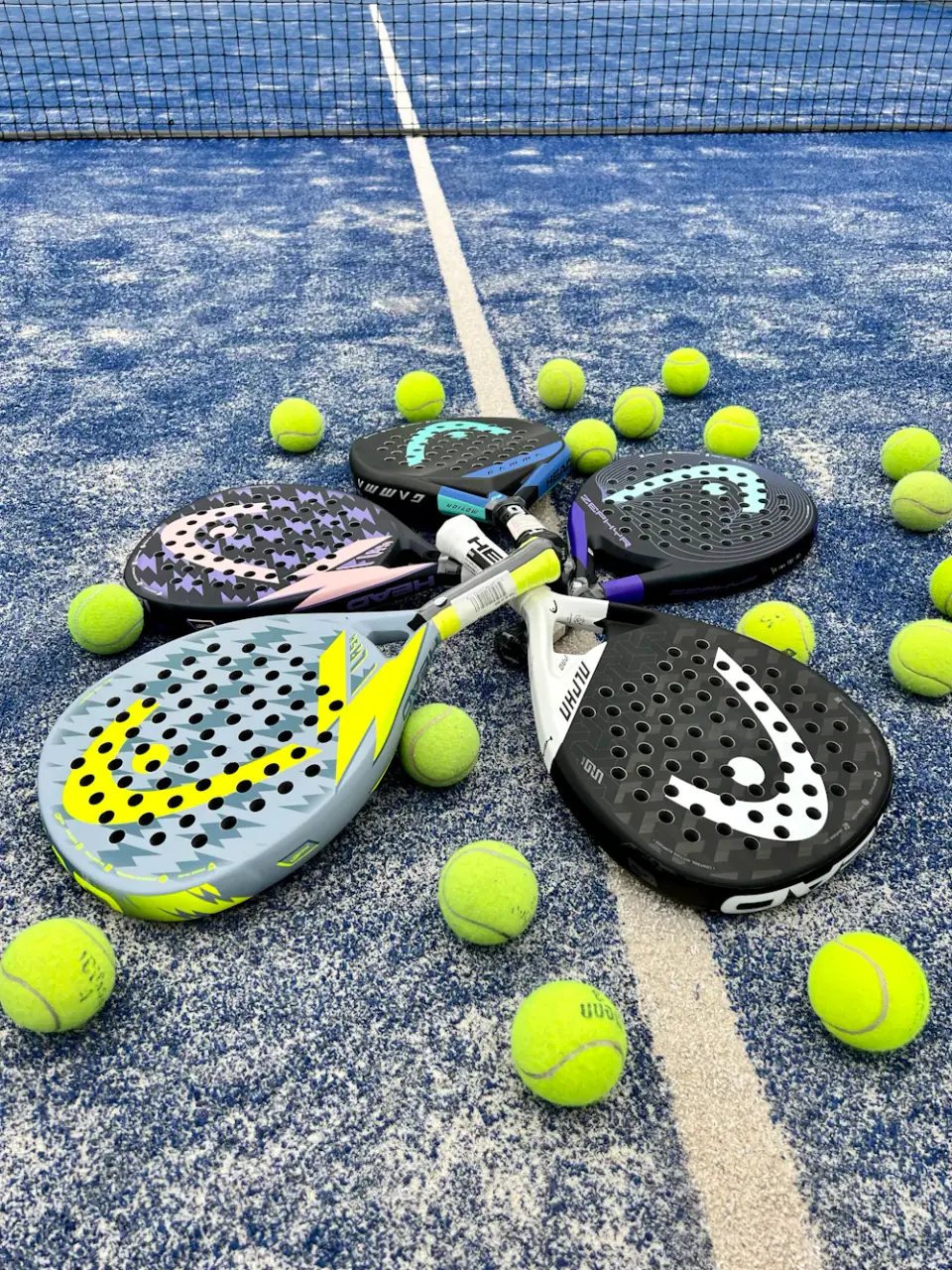 Padel rackets and balls on court (illustrative)