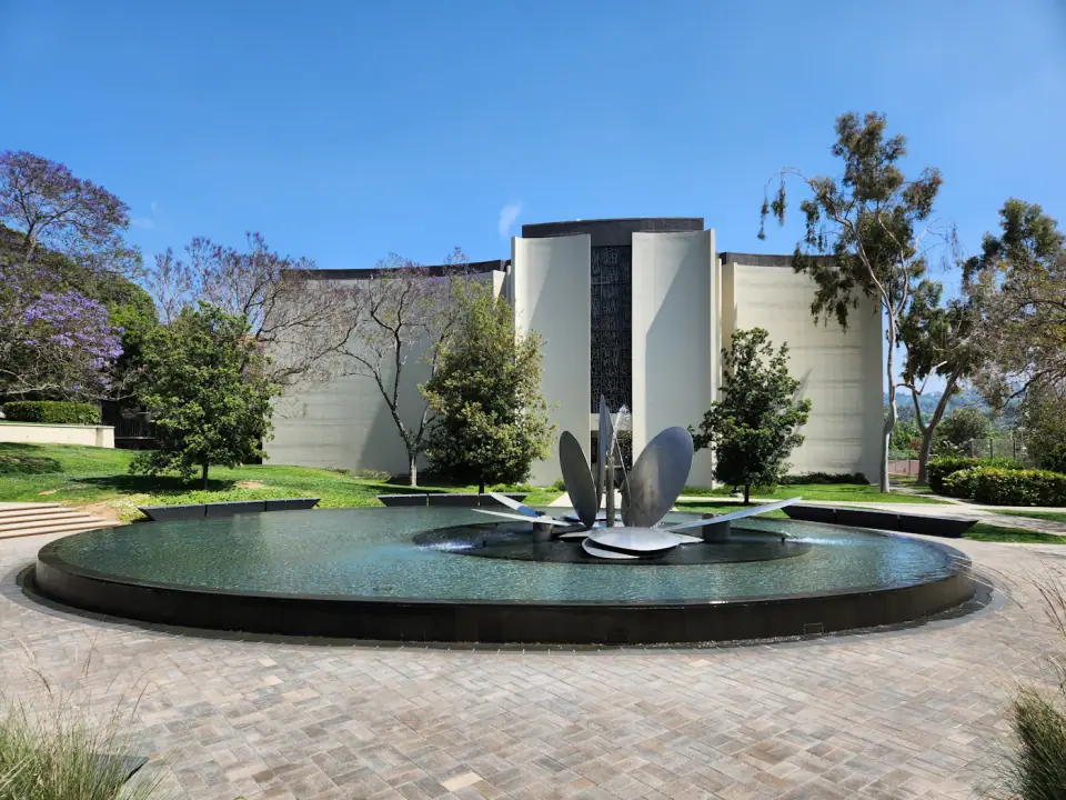Reflecting pool and fountain in a landscaped plaza (illustrative)
